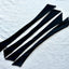 Flat Lay photo of Bikini Flavors interchangeable bow ties in Inkberry (black)