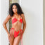 Bikini model wearing Cherry Crush reversible triangle top by Bikini Flavors. Red reverses to orange with interchangeable string ties! American made.