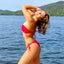 Bikini Flavors model wearing a reversible bandeau bikini top and Brazilian tie-side bikini bottoms in Red Sangria. American Made.