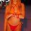 Bikini Flavors model wearing reversible ruffled triangle top and Brazilian bikini bottoms in Cherry Crush. American Made.