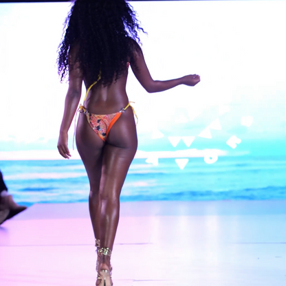 Model walking the runway at Miami Swim Week wearing Bikini Flavors reversible Monokini  cut out.  