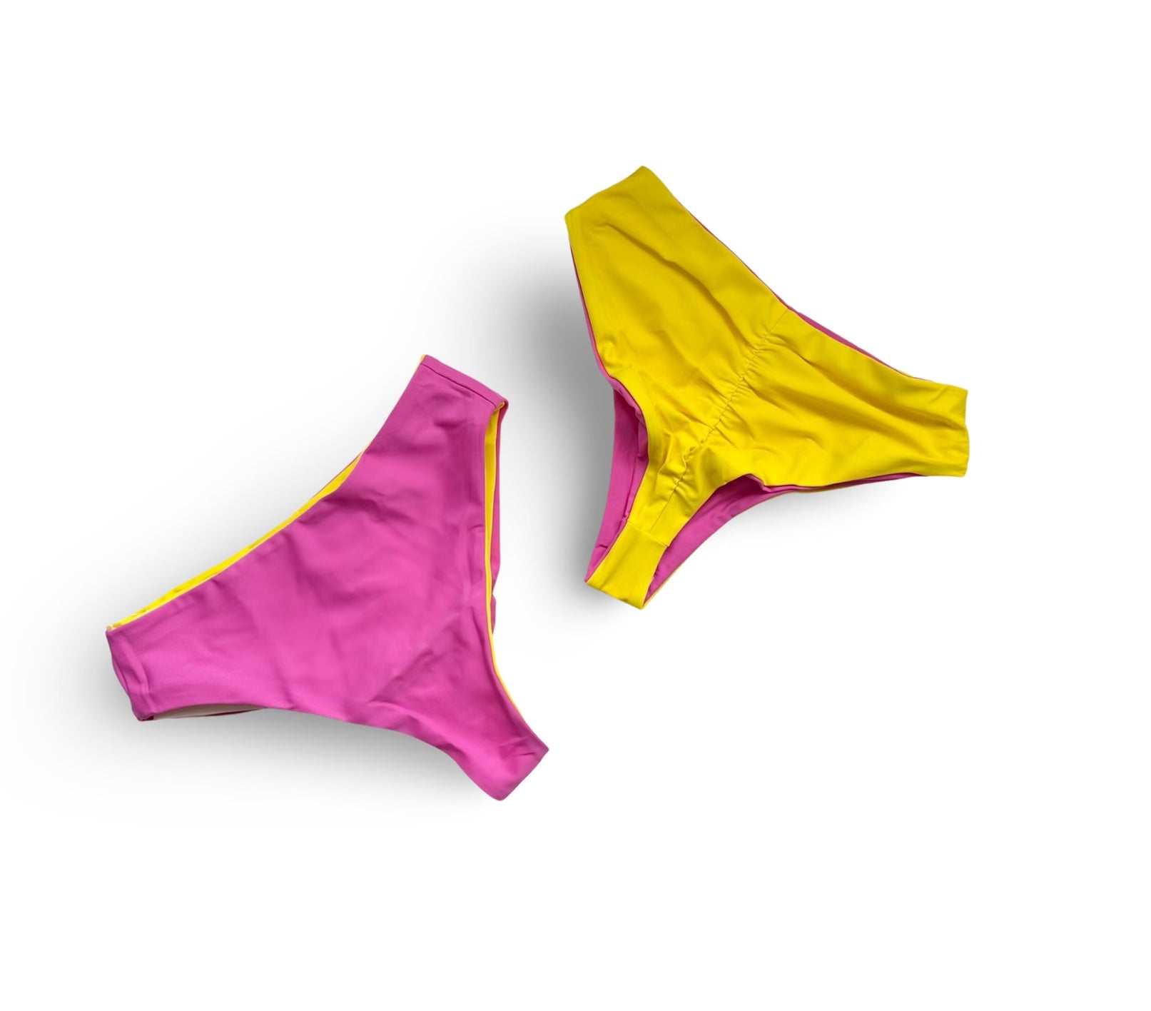 Reversible High waist cheeky bikini bottoms by Bikini Flavors shown in Strawberry Sunrise.  Pink reverses to yellow.  American Made. 