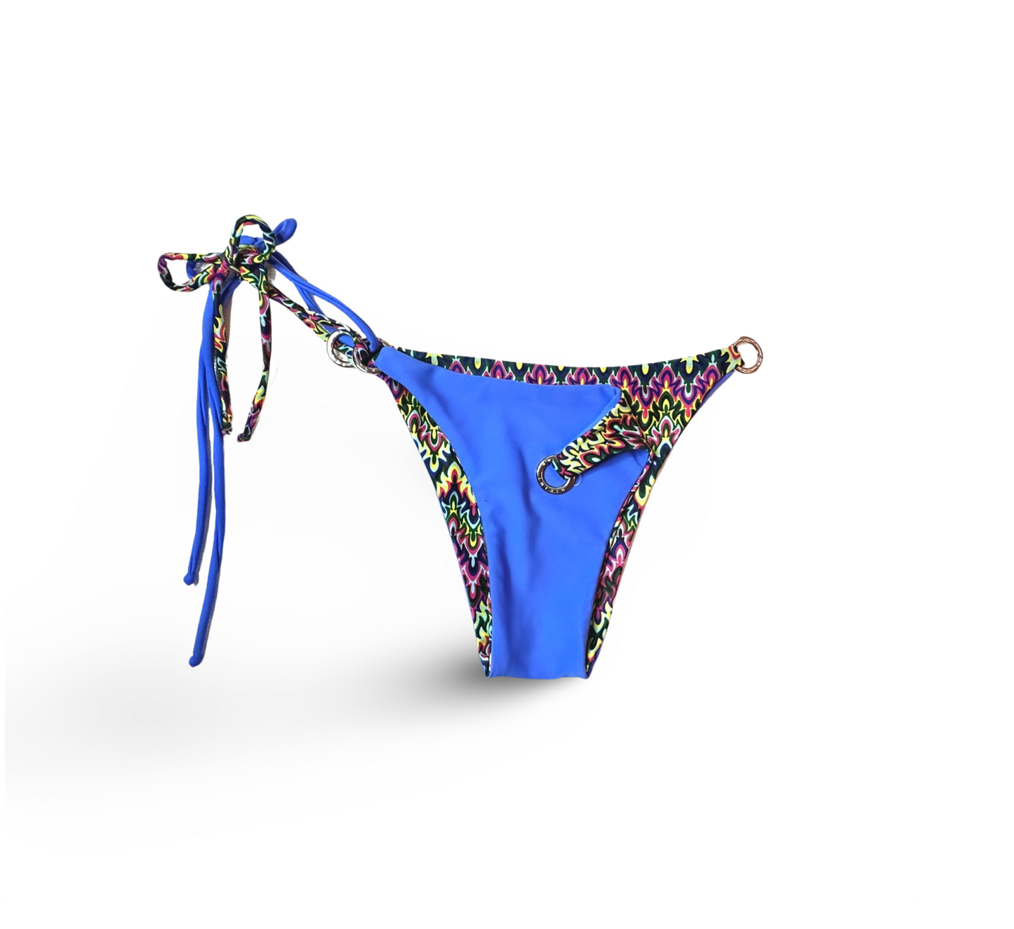 Reversible Brazilian bikini bottom in Blue Sapphire by Bikini Flavors.  Periwinkle blue reverses to colorful print. Interchangeable ties, signature hardware.  American Made. 